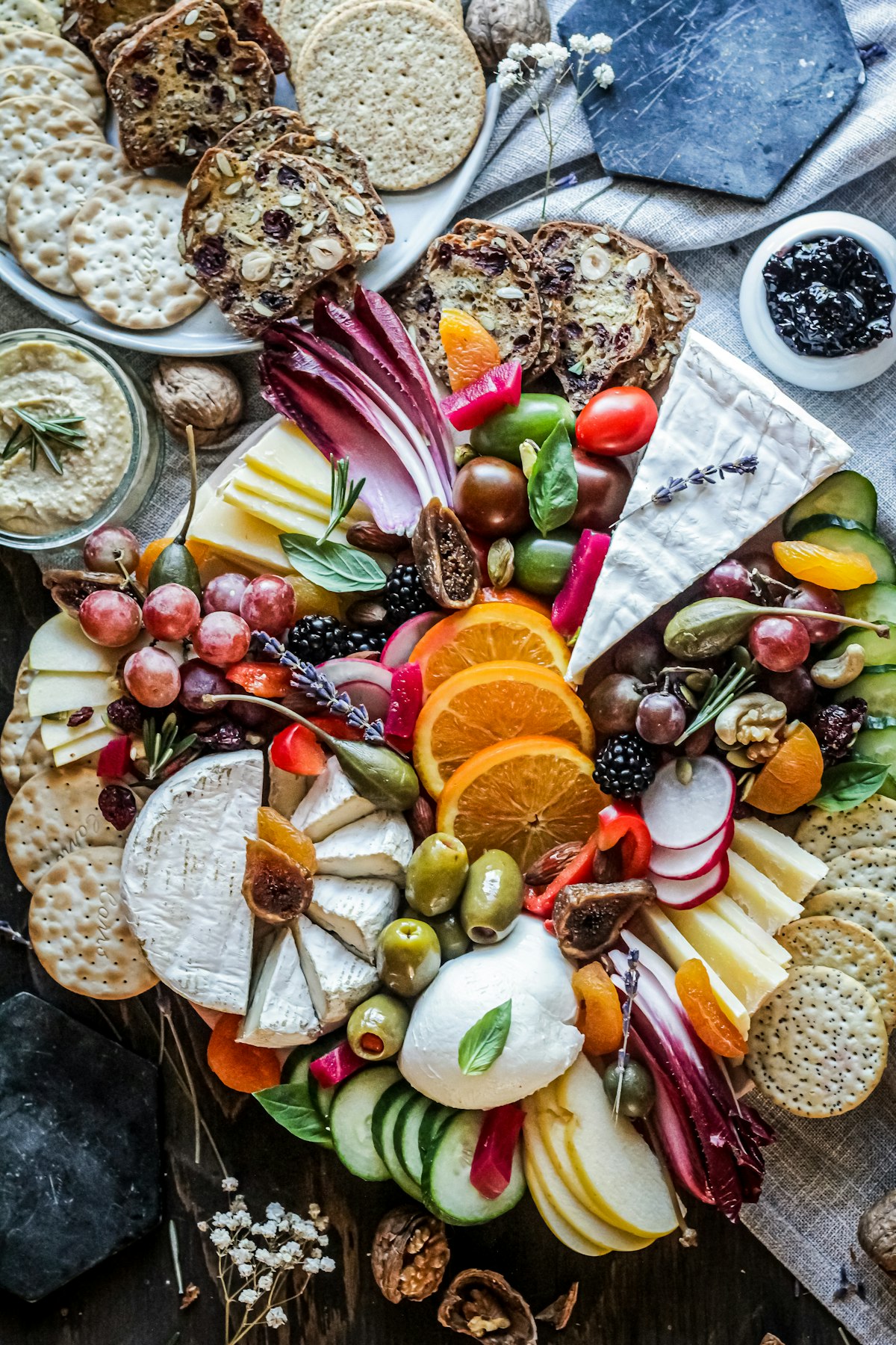 An elegant Veloura charcuterie platter styled with fresh herbs, cheese and cured meats